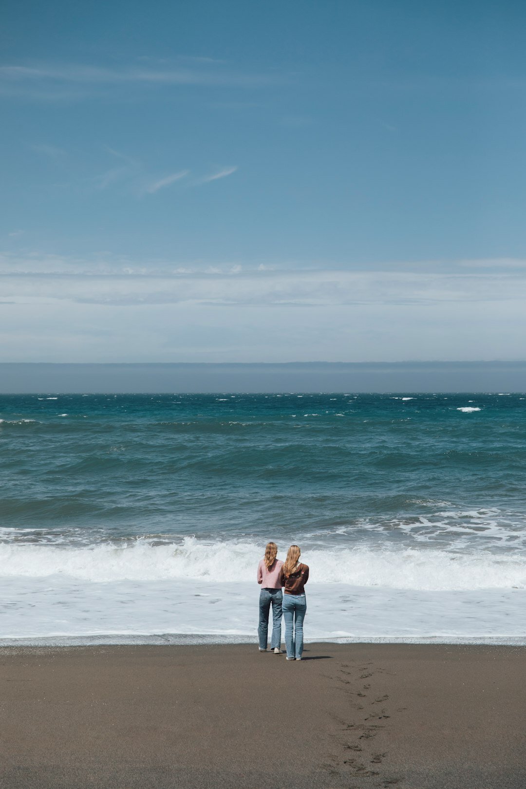 retired couple walking on beach