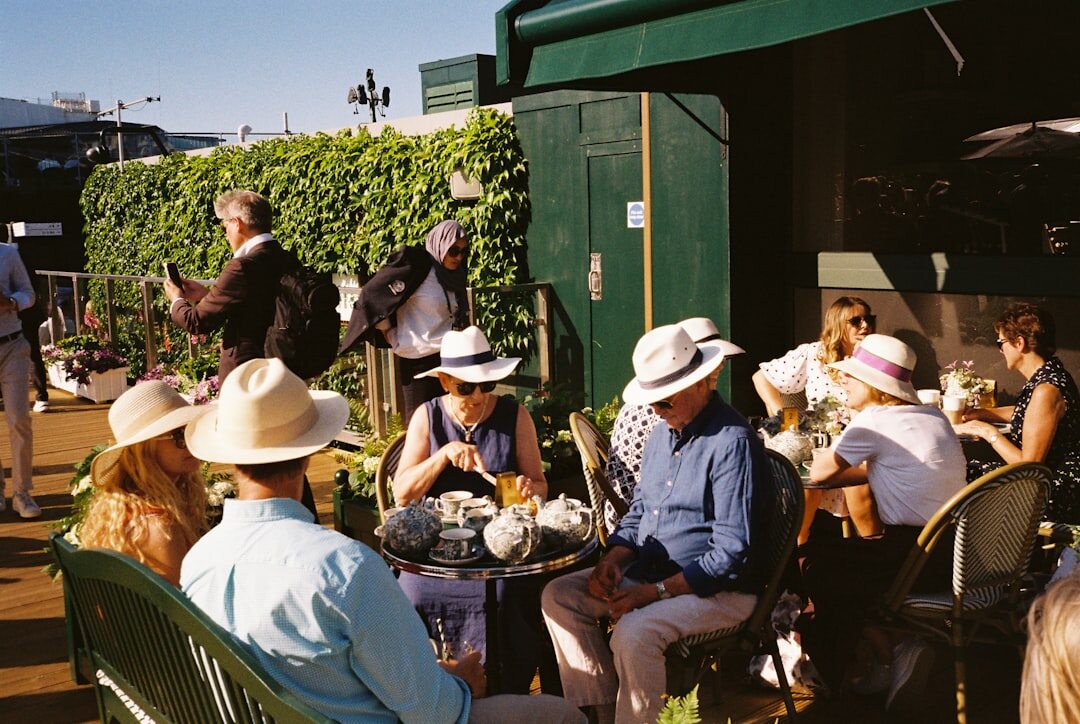 Group of older adults enjoying drinks together on a sunny terrace