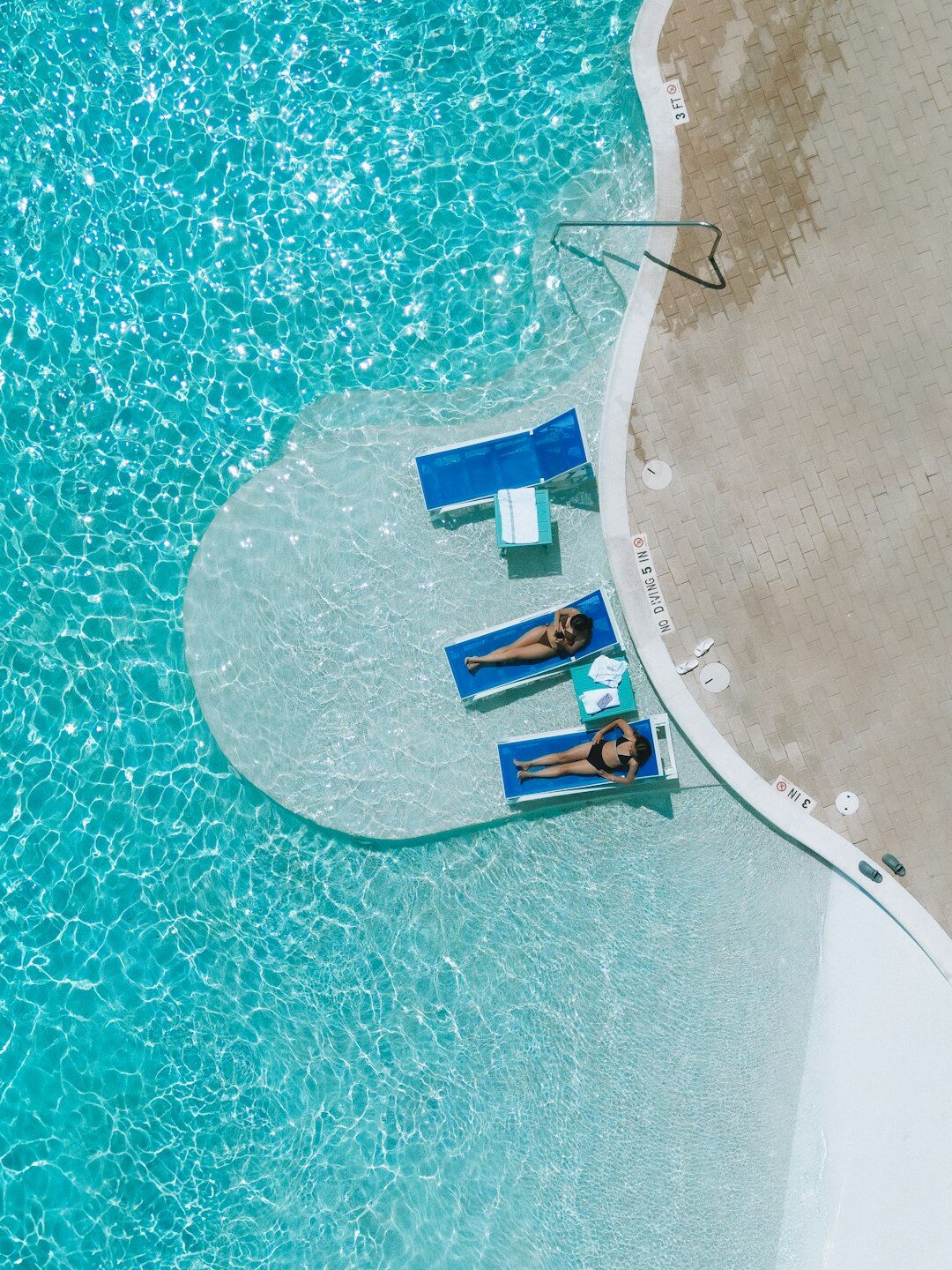 senior relaxing in luxury pool