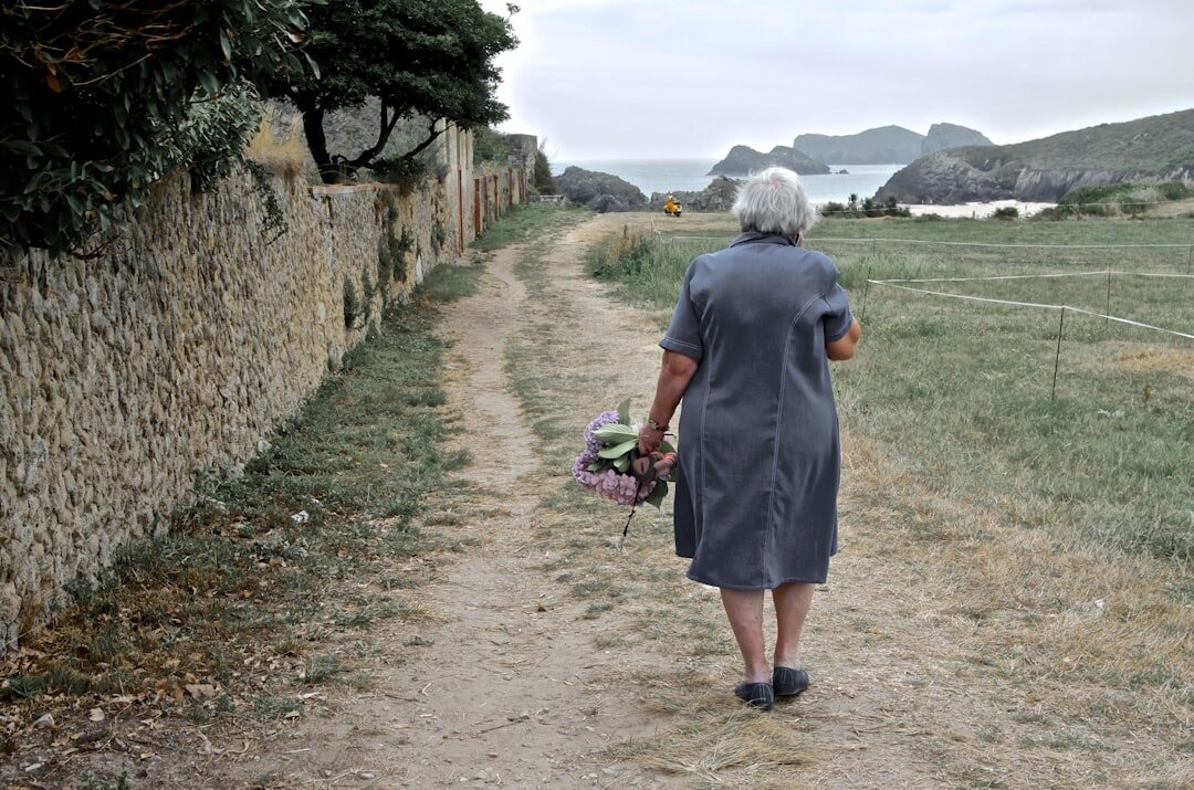 senior woman painting landscape