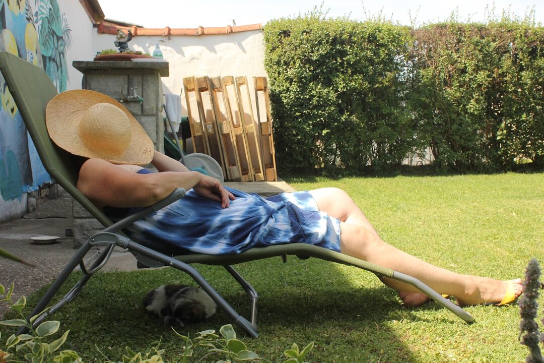 elderly man reading book in garden