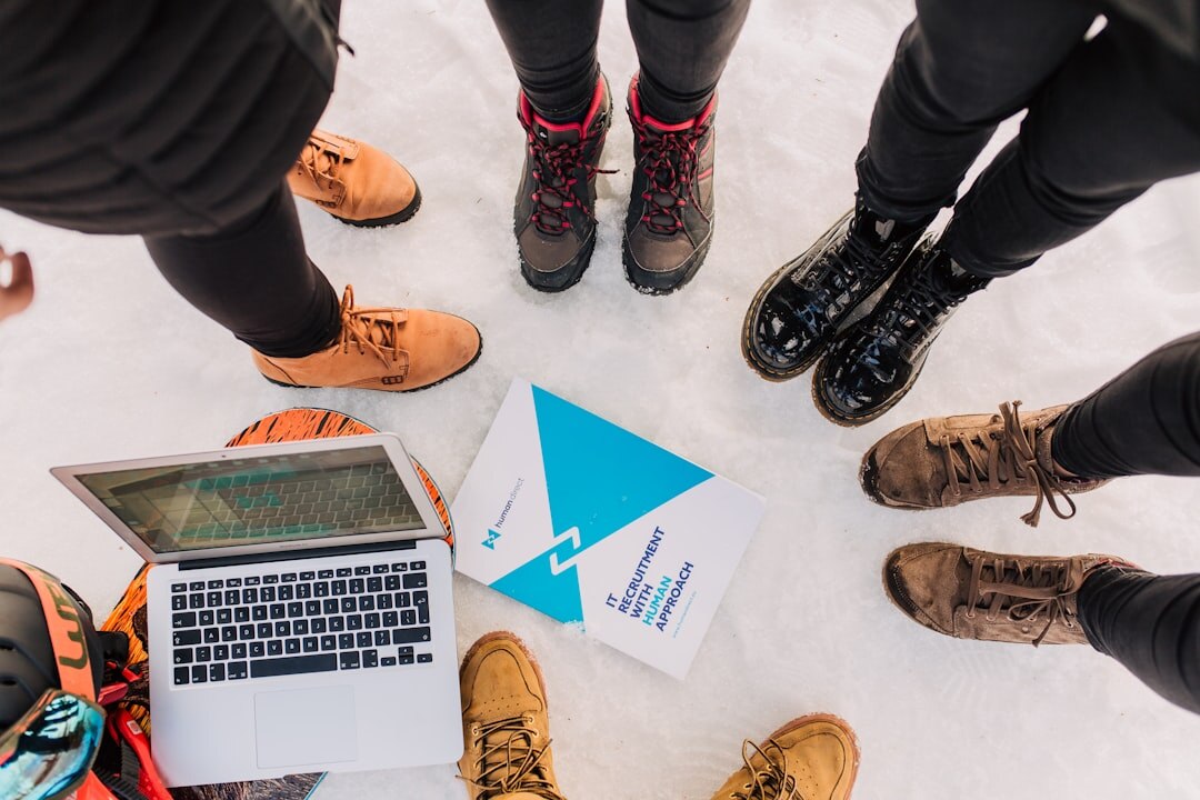 Small team meeting around a table with maps and laptops