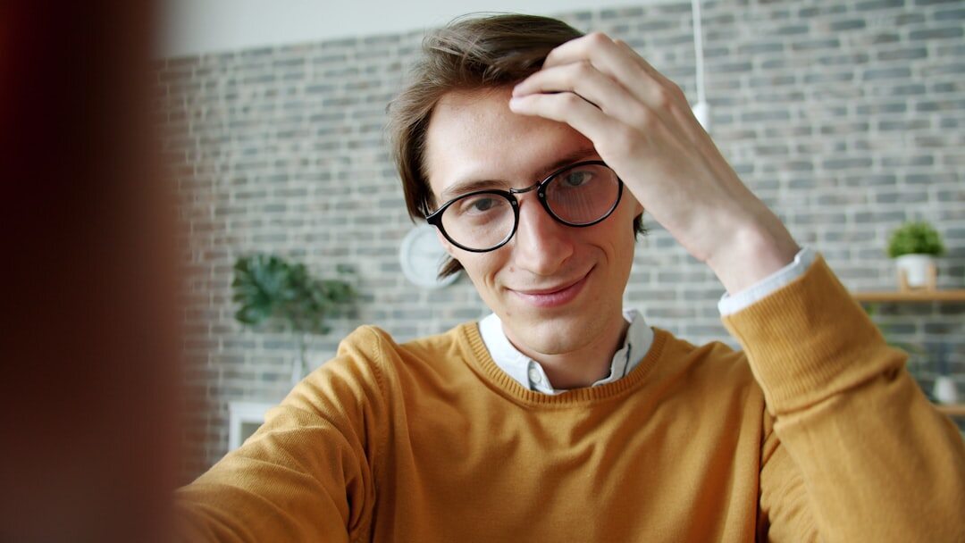 Studio portrait of a Dutch man in his fifties with glasses and a friendly smile